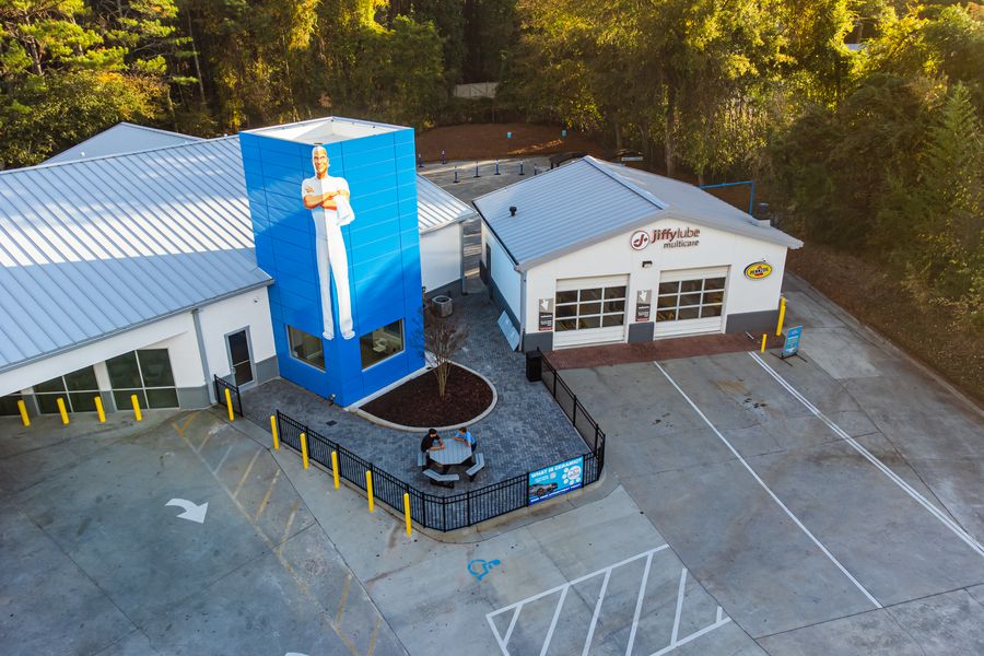 Aerial view of a Mr. Clean Car Wash site surrounded by trees