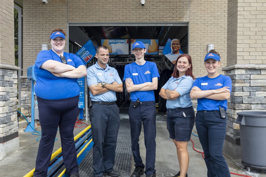 The Mr. Clean Car Wash team outside the wash bays